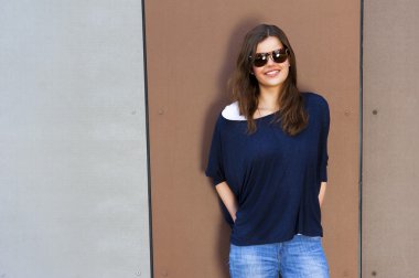 Kocaman bir gülümseme ile dijital tablet bilgisayar kullanan genç kadın