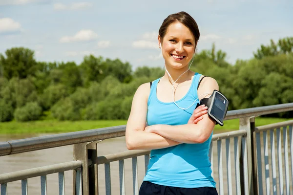 Young tired woman rest after run in the city over the bridge smi — Stock Photo, Image