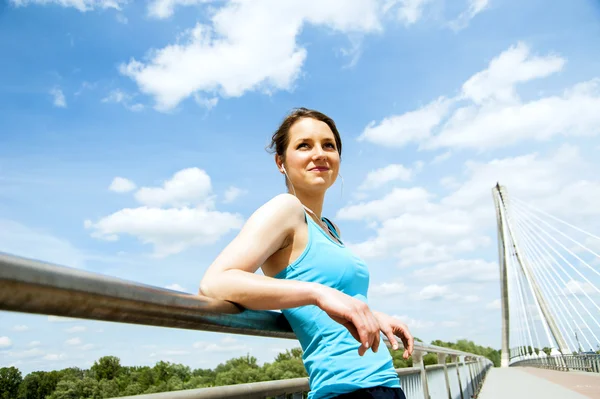 Young tired woman rest after run in the city over the bridge. — Stock Photo, Image