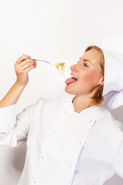 Woman chef with fork and spaghetti pasta noodles, eting against — Stock Photo, Image