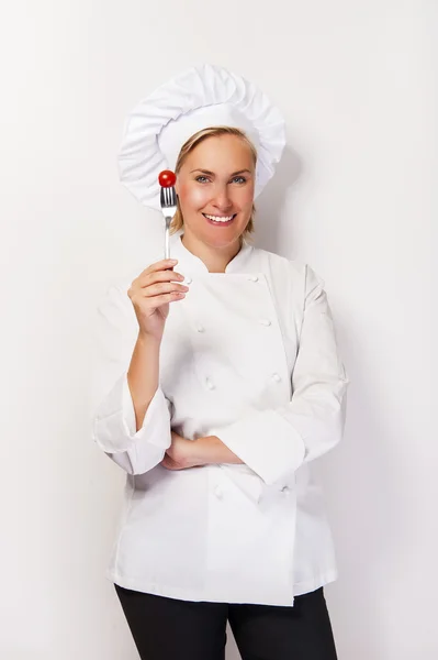 Woman chef showing a sign perfect, with tomato on fork, over whi — Stock Photo, Image