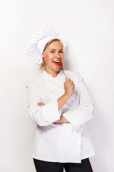 Woman chef showing a sign perfect, with tomato on fork, over whi — Stock Photo, Image