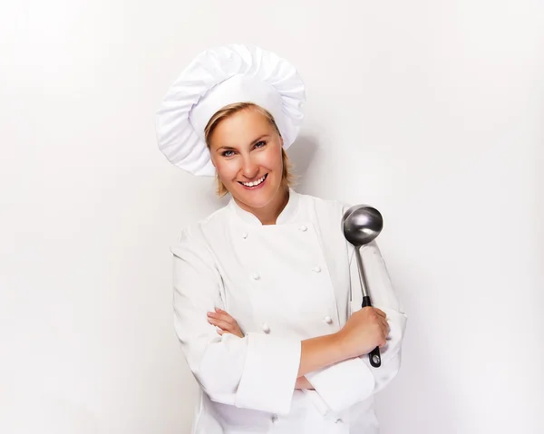 Young woman chef holding ladle, smiling. — Stock Photo, Image