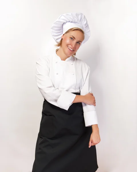 Šéfkuchař žena s úsměvem nad bílým základy. — Stock fotografie