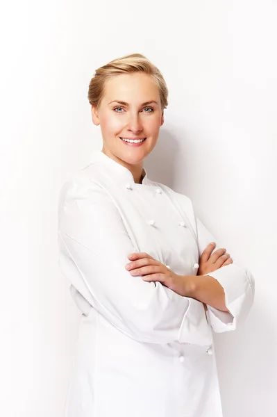 Young woman chef smiling over white background in chef's outfit. — Stock Photo, Image