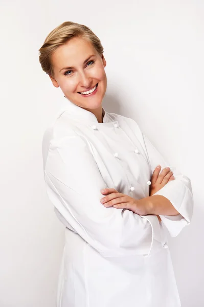 Chef woman over white background with crosed arms smiling with c — Stock Photo, Image