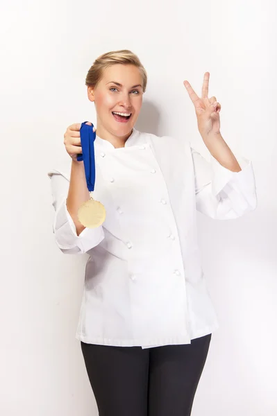Woman in chef outfit and first prize medal smiling. Showing two — Stock Photo, Image