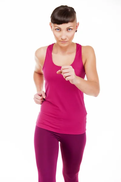 Vrouw in fitness outfit uitgevoerd, geïsoleerd op witte achtergrond. — Stockfoto