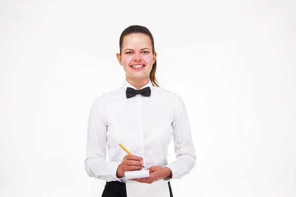 Jonge vrouw in Ober uniforme bedrijf Kladblok over witte backgro — Stockfoto