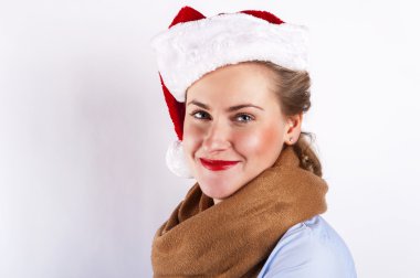 Beyaz arka plan üzerinde gülümseyen Noel şapkalı kadın.