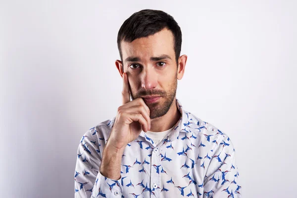 Man portriat over white background, thinking with hand near his — Stock Photo, Image