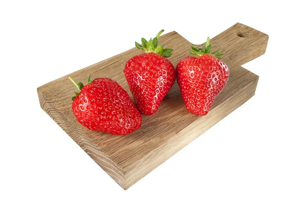 Drie aardbeien op een bureau — Stockfoto