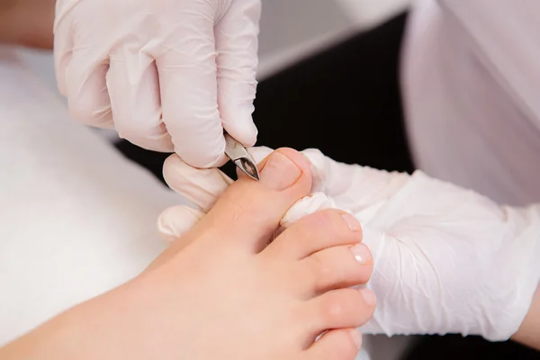 Close up pedicure process - at podiatry salon — Stock Photo, Image