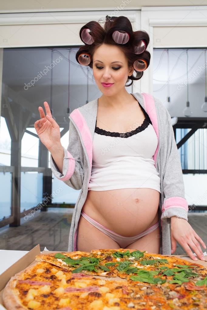 Pregnant woman eating pizza — Stock Photo © bdibdus 99557898