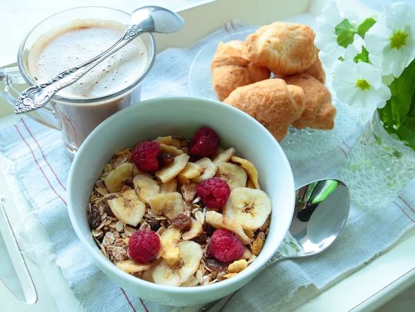 Bowl with cereals with fruits and cup of hot coffee for breakfast — Stock Photo, Image