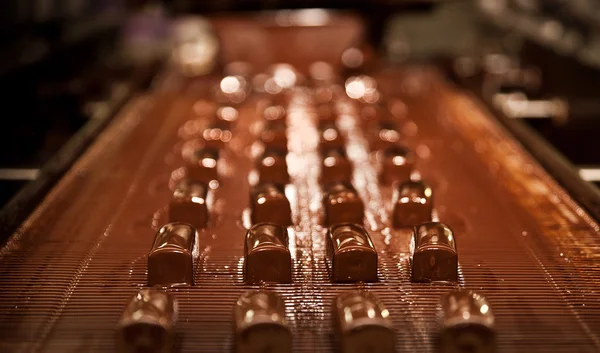 The production of sweet cottage cheese covered with chocolate — Stock Photo, Image