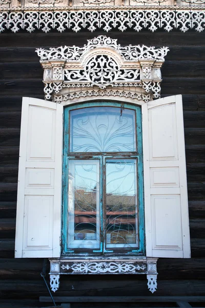 traditional ornament.  windows with wooden carvings on the windows in a wooden house