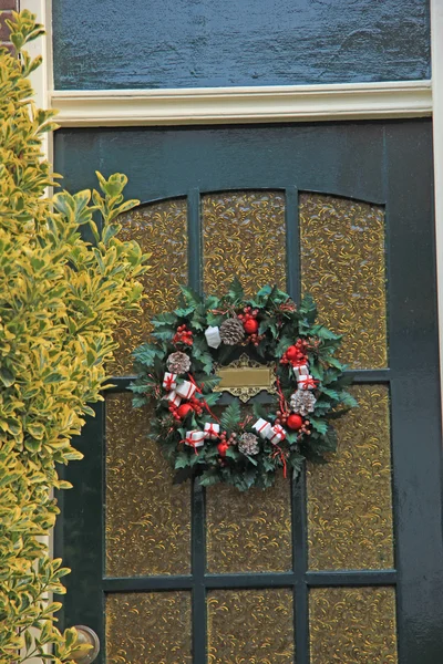 Classic christmas wreath with decorations on a door — Φωτογραφία Αρχείου