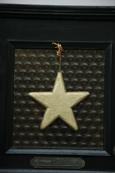 Golden star on glass door — Stock Photo, Image