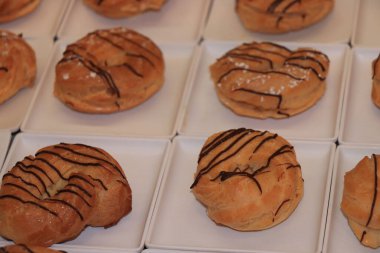 Profiteroller, kremayla dolu puf börekler, yolcu gemisi büfesinde sergileniyor.