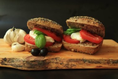 Taze domatesli İtalyan Caprese sandviçleri, mozzarella peyniri ve basi.