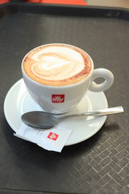 Barselona, İspanya - 29 Eylül 2019: Illy Cappuccino markalı bir kahve fincanında Illy şeker ve kalp çizimi sütlü sütlü latte sanatı olarak çizildi