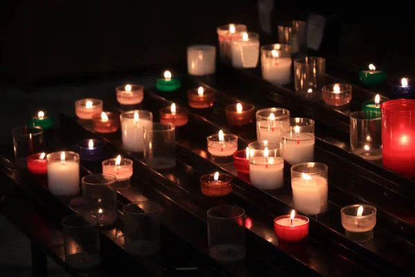 Burning votive candles in a Roman Catholic church