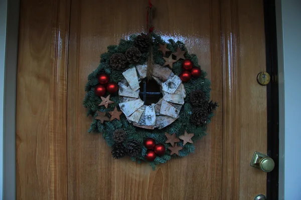 Χριστούγεννα στεφάνι με διακοσμήσεις σε μια πόρτα — Φωτογραφία Αρχείου
