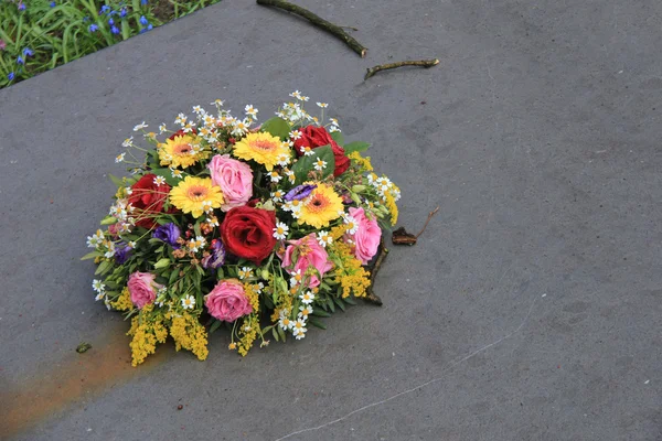 Συλλυπητήρια λουλούδια πάνω σε μια ταφόπλακα — Φωτογραφία Αρχείου