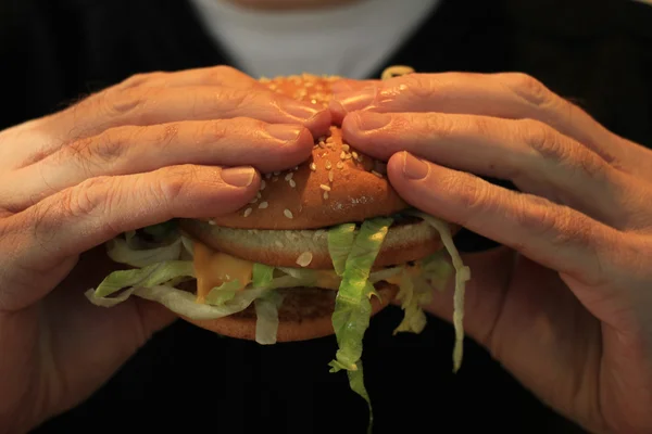 Man holding a hamburger — Stock Photo, Image