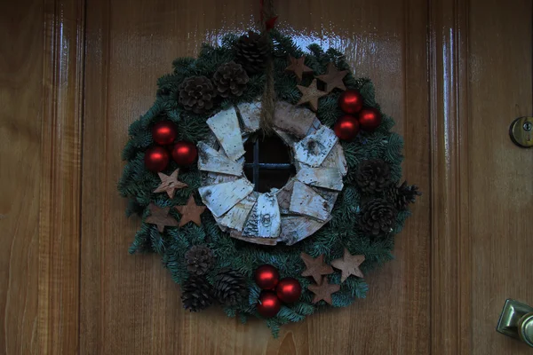 Grinalda de Natal com decorações em uma porta — Fotografia de Stock