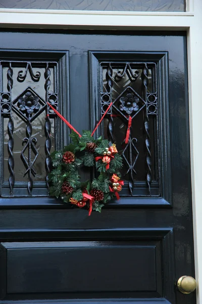 Classic christmas wreath with decorations on a door — Φωτογραφία Αρχείου