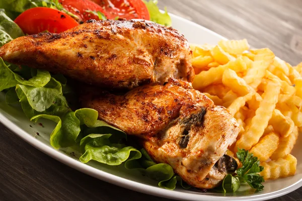 Roasted chicken breast, French fries and vegetables