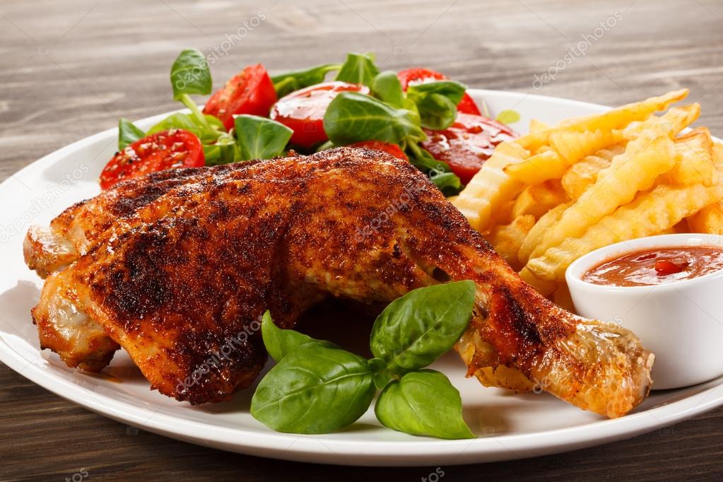 Grilled chicken leg, chips and vegetables — Stock Photo © gbh007 117052162