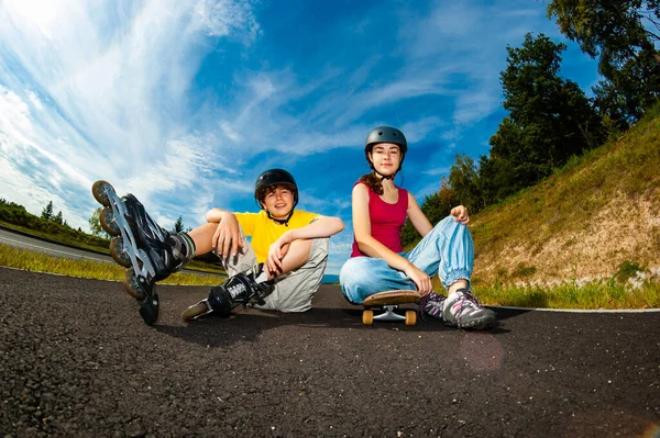 Happy young people rollerblading, skateboarding