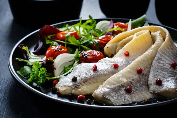 Marinated Herrings Roast Cherry Tomatoes Fresh Vegetable Leaves Black Table — Stock Photo, Image