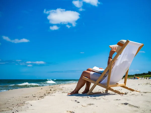 Woman Relaxing Beach Reading Book Sitting Sunbed Stock Photo