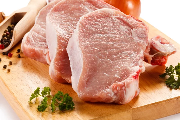 Frisches rohes Schweinefleisch auf Schneidebrett — Stockfoto