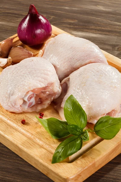 Raw chicken legs on cutting board — Stock Photo, Image