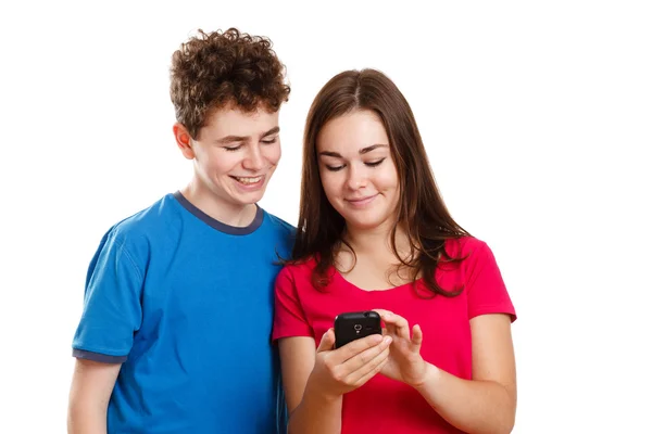 Boy and girl using mobile phone — Stock Photo, Image