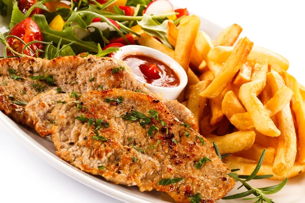 Fried pork, French fries and vegetables — Stock Photo, Image