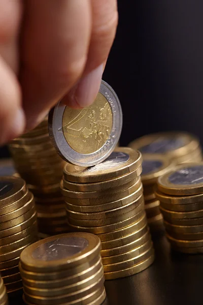 Businessman with stacks of coins — Stock Photo, Image