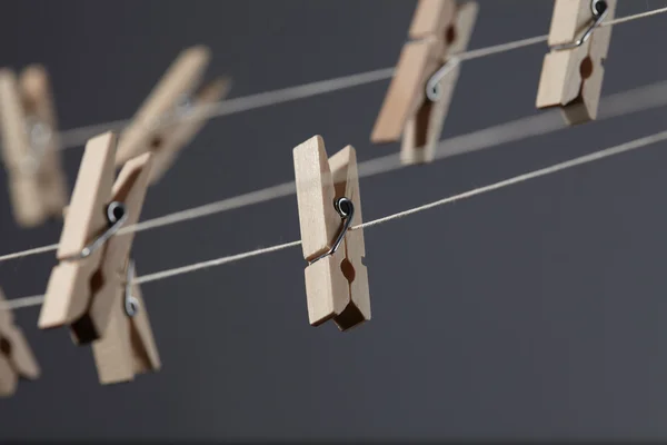 Wooden clothespins on a ropes — Stock Photo, Image