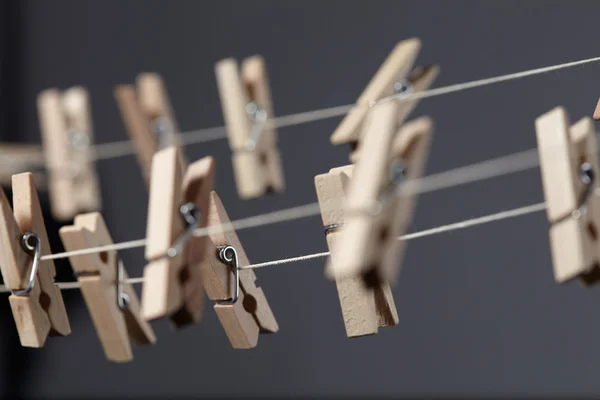 Wooden clothespins on a ropes — Stock Photo, Image