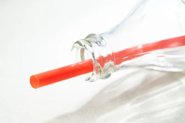 Empty bottle and straw — Stock Photo, Image