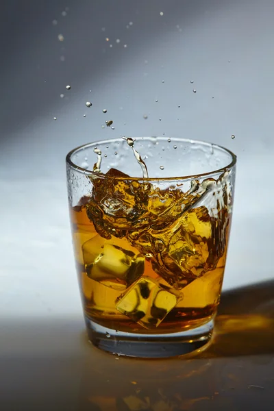 Glass of whiskey with ice — Stock Photo, Image