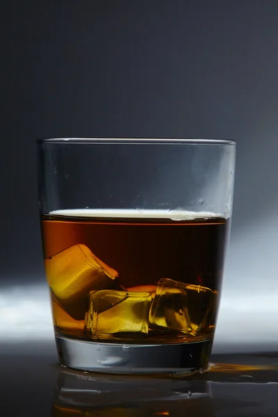 Whiskey in glass with ice — Stock Photo, Image