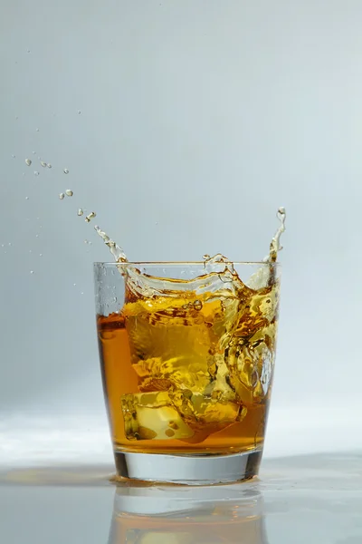 Whiskey in glass with ice — Stock Photo, Image