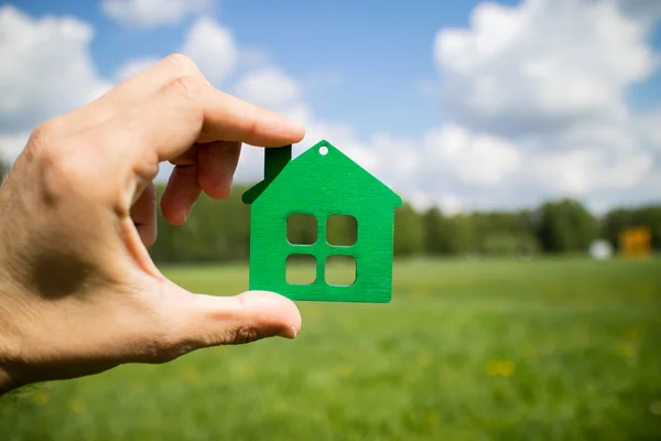 Male hand with house model — Stock Photo, Image