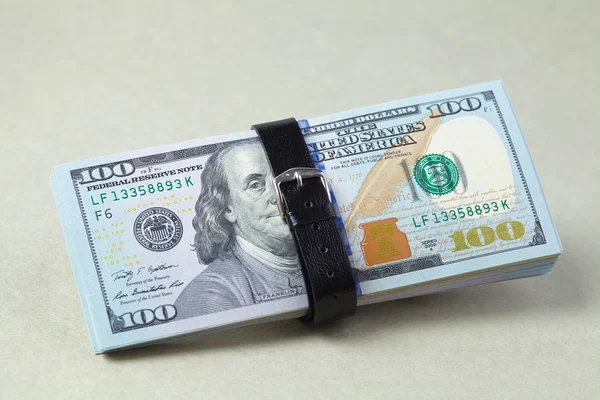 Dólares con cinturón en gris — Foto de Stock